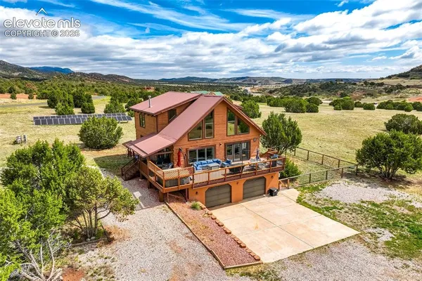 an aerial view of a house with a big yard