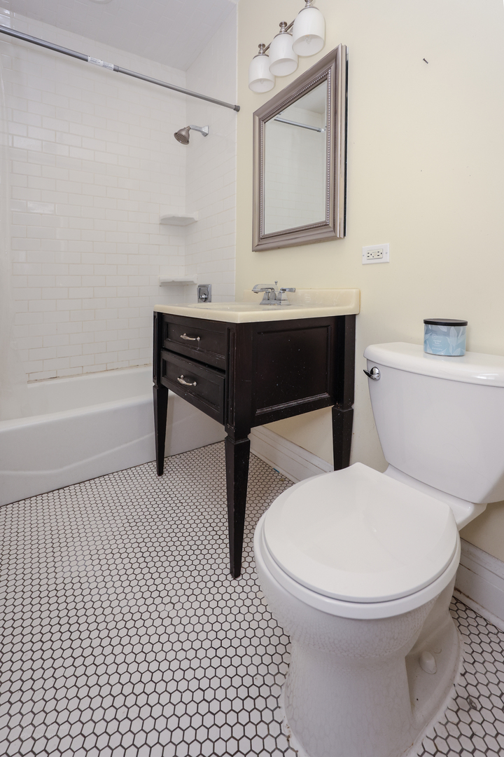 815 Mason Avenue, Unit 2 Joliet, IL 60435 - Photo 13 of 13 a bathroom with a toilet a sink and mirror