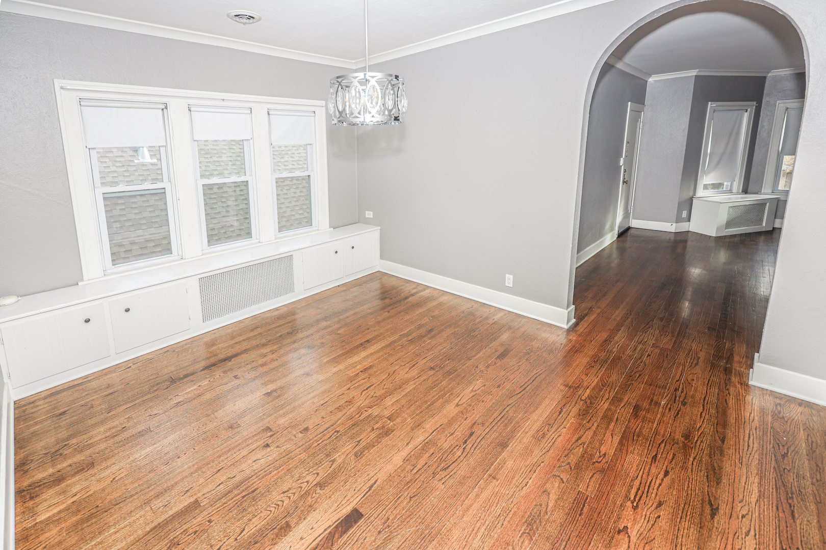 815 Mason Avenue, Unit 2 Joliet, IL 60435 - Photo 5 of 13 an empty room with wooden floor and windows