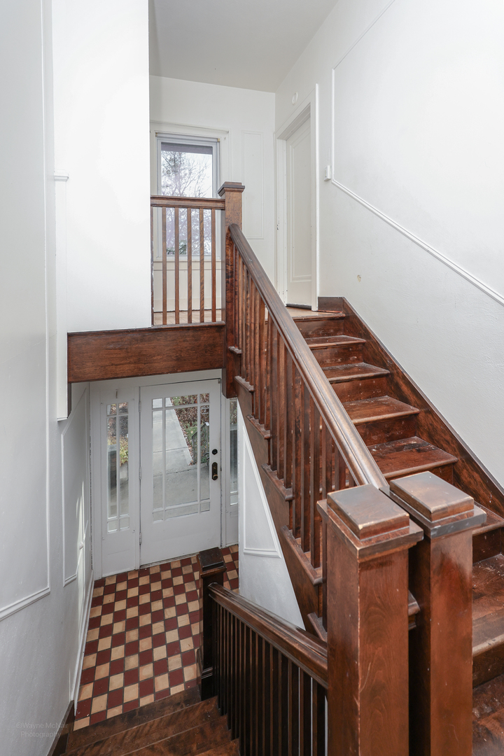 815 Mason Avenue, Unit 2 Joliet, IL 60435 - Photo 10 of 13 a view of staircase with wooden floor and white walls