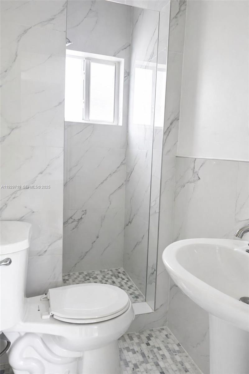 3071 Southwest 27th Lane, Unit 3 Miami, FL 33133 - Photo 5 of 7 a bathroom with a toilet and a shower