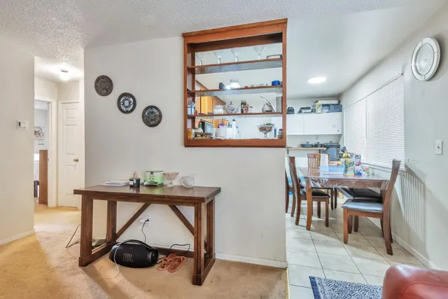 a view of a dining room with furniture and a chandelier