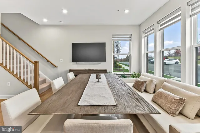 a dining room with stainless steel appliances kitchen island a table and chairs