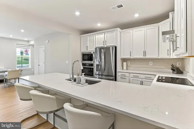 a kitchen with stainless steel appliances white cabinets and a granite counter tops