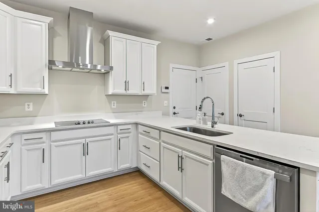a kitchen with granite countertop white cabinets and a white stove