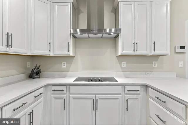 a kitchen with a sink and living room