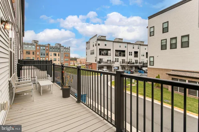 a view of a balcony with chairs and wooden floor