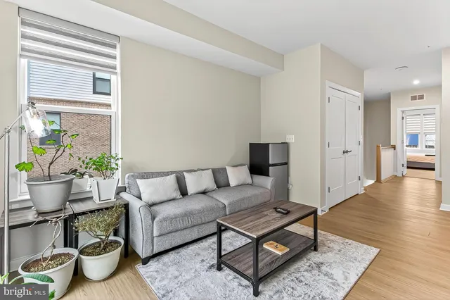 a bed sitting in a spacious bedroom next to a window