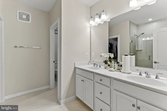 a large bed sitting in a bedroom next to a window