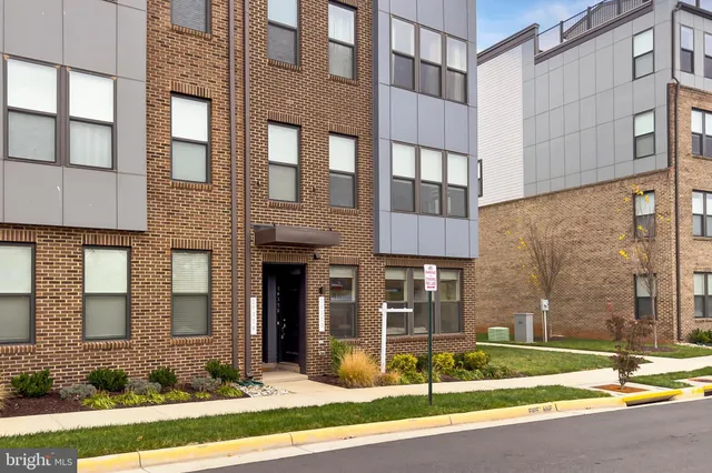 a view of a brick building next to a yard