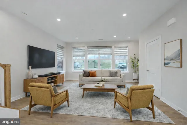 a large kitchen with a center island wooden floor stainless steel appliances and cabinets