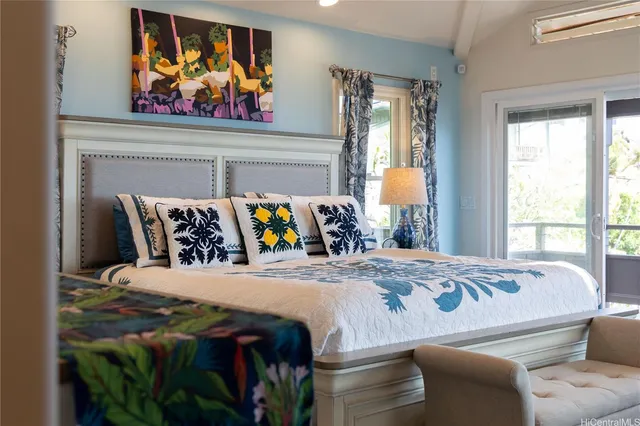 a bed sitting in a bedroom next to a window