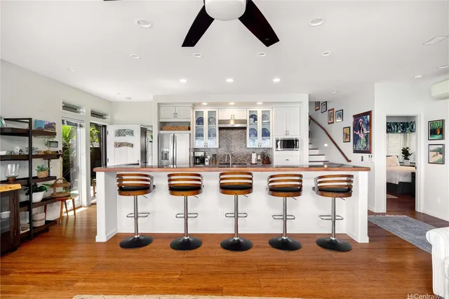 a kitchen with stainless steel appliances kitchen island granite countertop a table and chairs