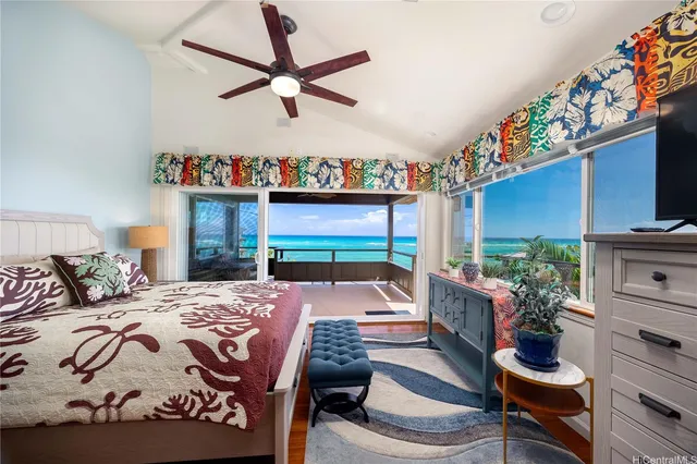 a bedroom with a bed a couch and a potted plant