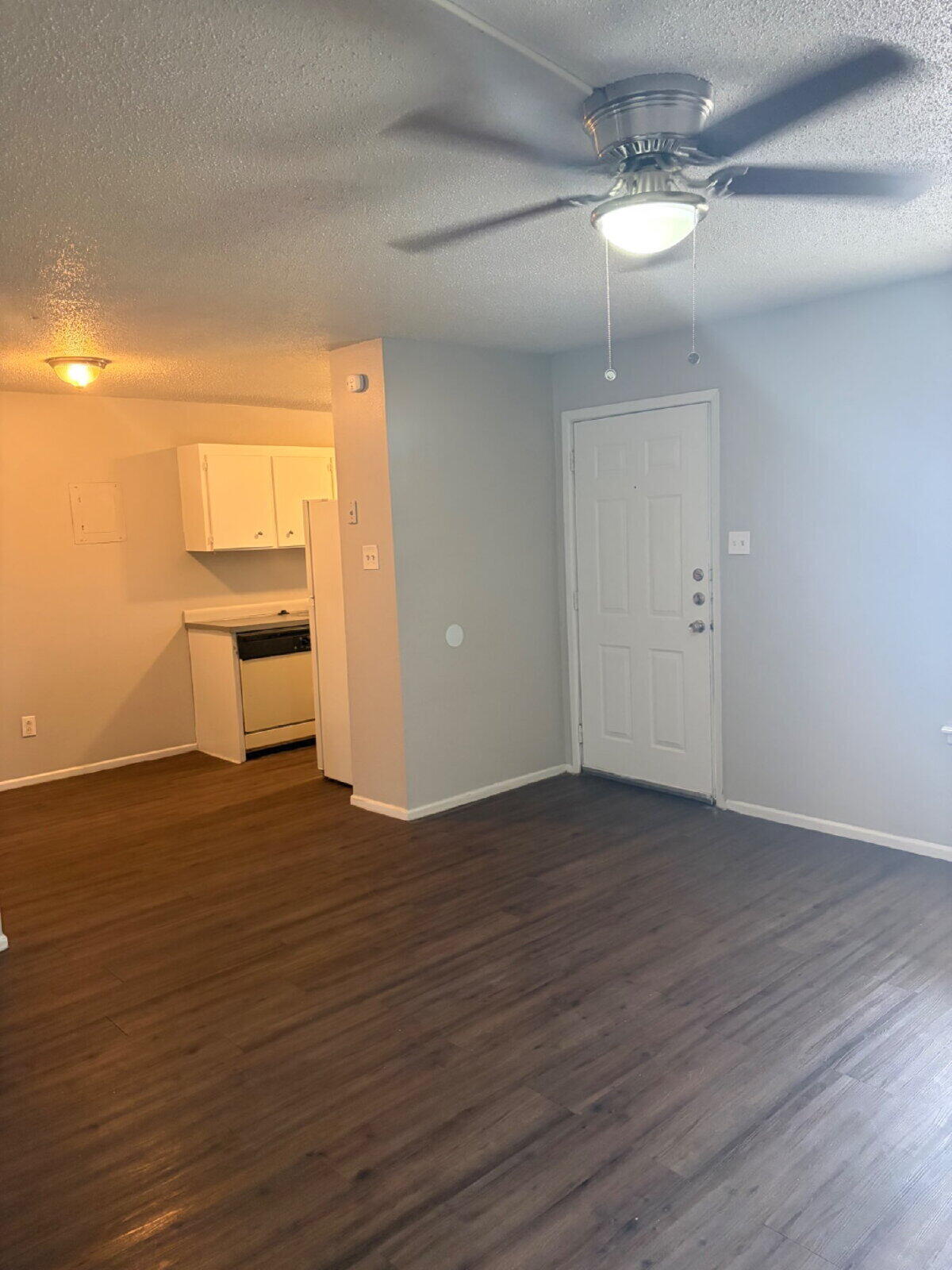 3211 35th Street, Unit A Lubbock, TX 79413 - Photo 9 of 16 a view of an empty room with glass door and wooden floor
