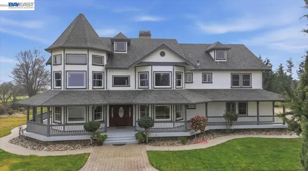 a front view of a house with a garden and patio