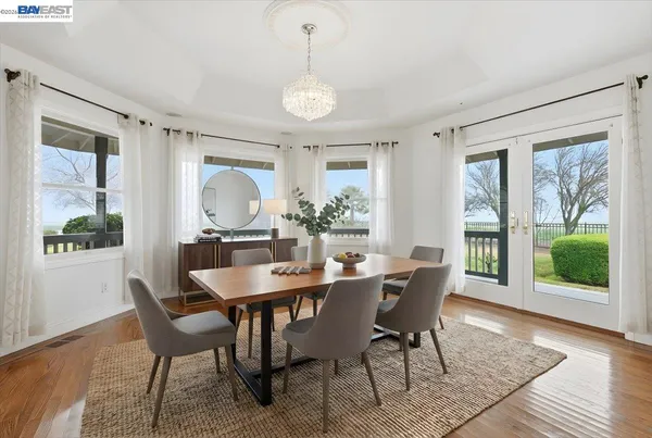 a kitchen with stainless steel appliances granite countertop a stove a sink dishwasher and a microwave oven with wooden floor