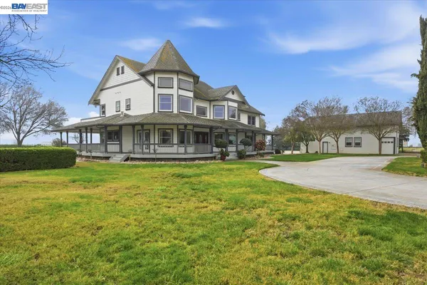 a front view of a house with swimming pool having outdoor