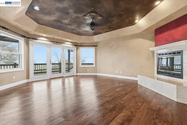 a dining room with furniture a chandelier and wooden floor