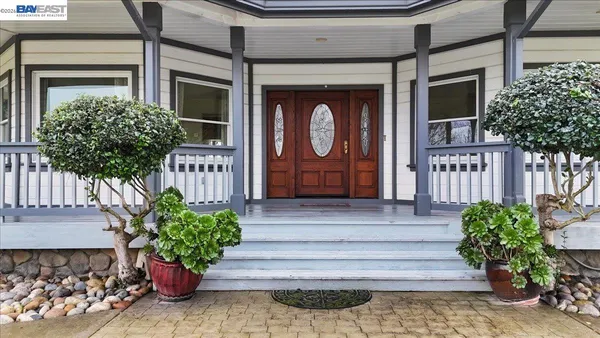 a front view of a house with potted plants