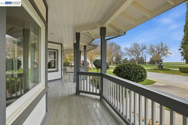 a view of a balcony with wooden floor