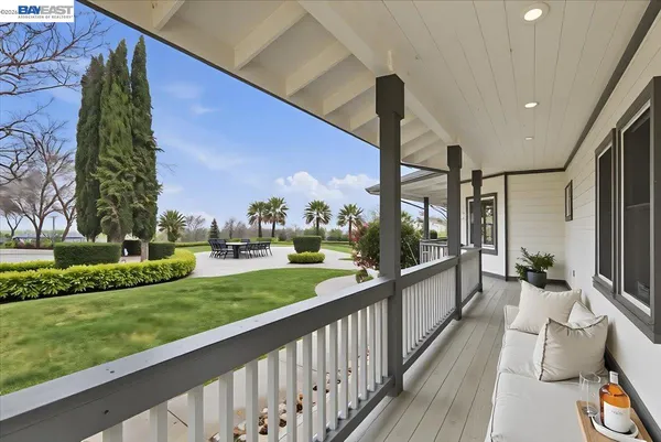 a view of a hallway with wooden floor and stairs