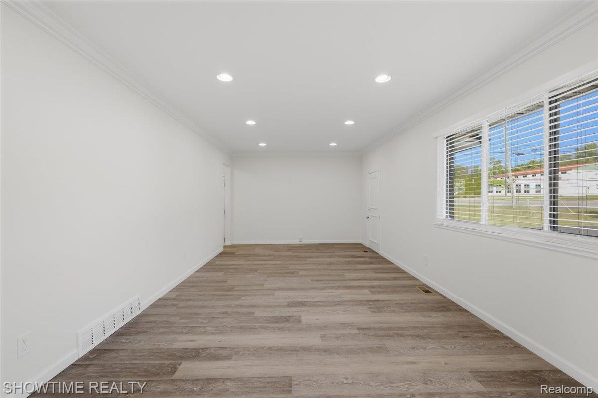 29255 Utley Road Farmington, MI 48334 - Photo 9 of 46 Recessed lighting, wood-finish flooring, white walls, and a large window with horizontal blinds