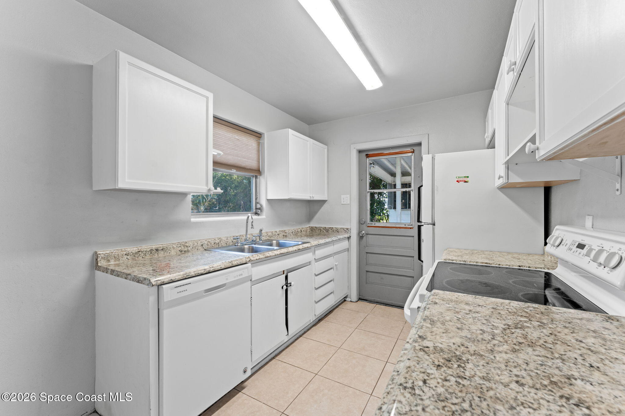 1042 Azalea Lane Cocoa, FL 32922 - Photo 11 of 26 a kitchen with a sink stove and cabinets