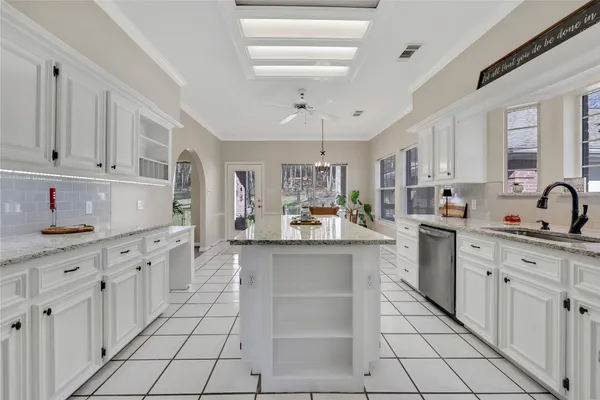 a kitchen with stainless steel appliances granite countertop a sink and cabinets