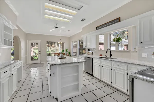 a kitchen with a sink cabinets and window