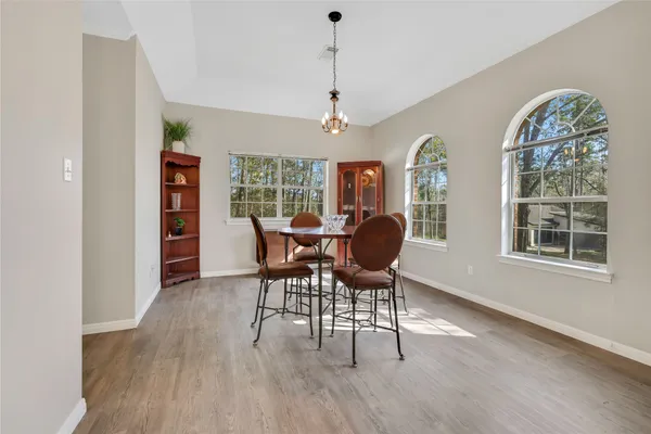 a view of a dining room with furniture window and wooden floor