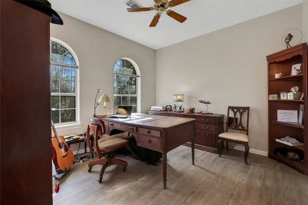 a view of a workspace with furniture and a window