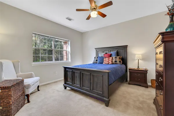 a bed sitting in a bedroom next to a window