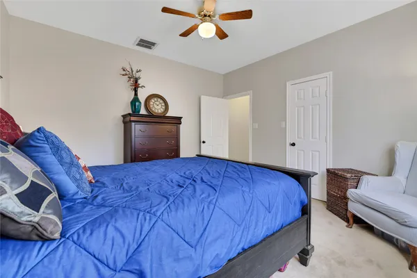 a bedroom with a bed and a couch