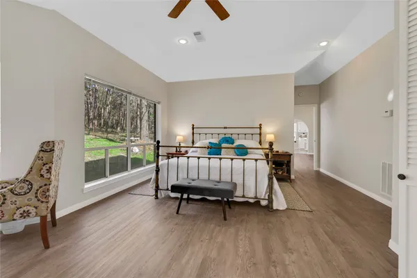 a bed room with a bed and a large window