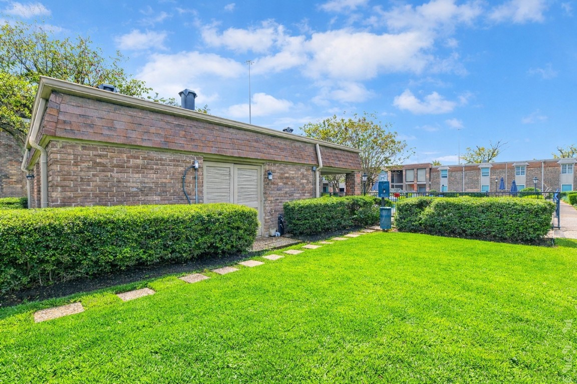 7575 Katy Freeway, Unit 101 Houston, TX 77024 - Photo 20 of 21 a view of a back yard of the house with a large tree