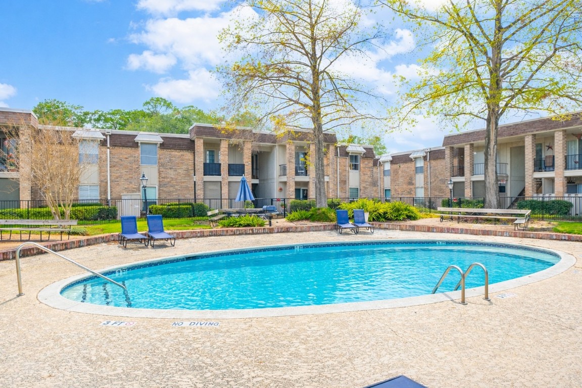 7575 Katy Freeway, Unit 101 Houston, TX 77024 - Photo 21 of 21 a view of a house with swimming pool and a yard