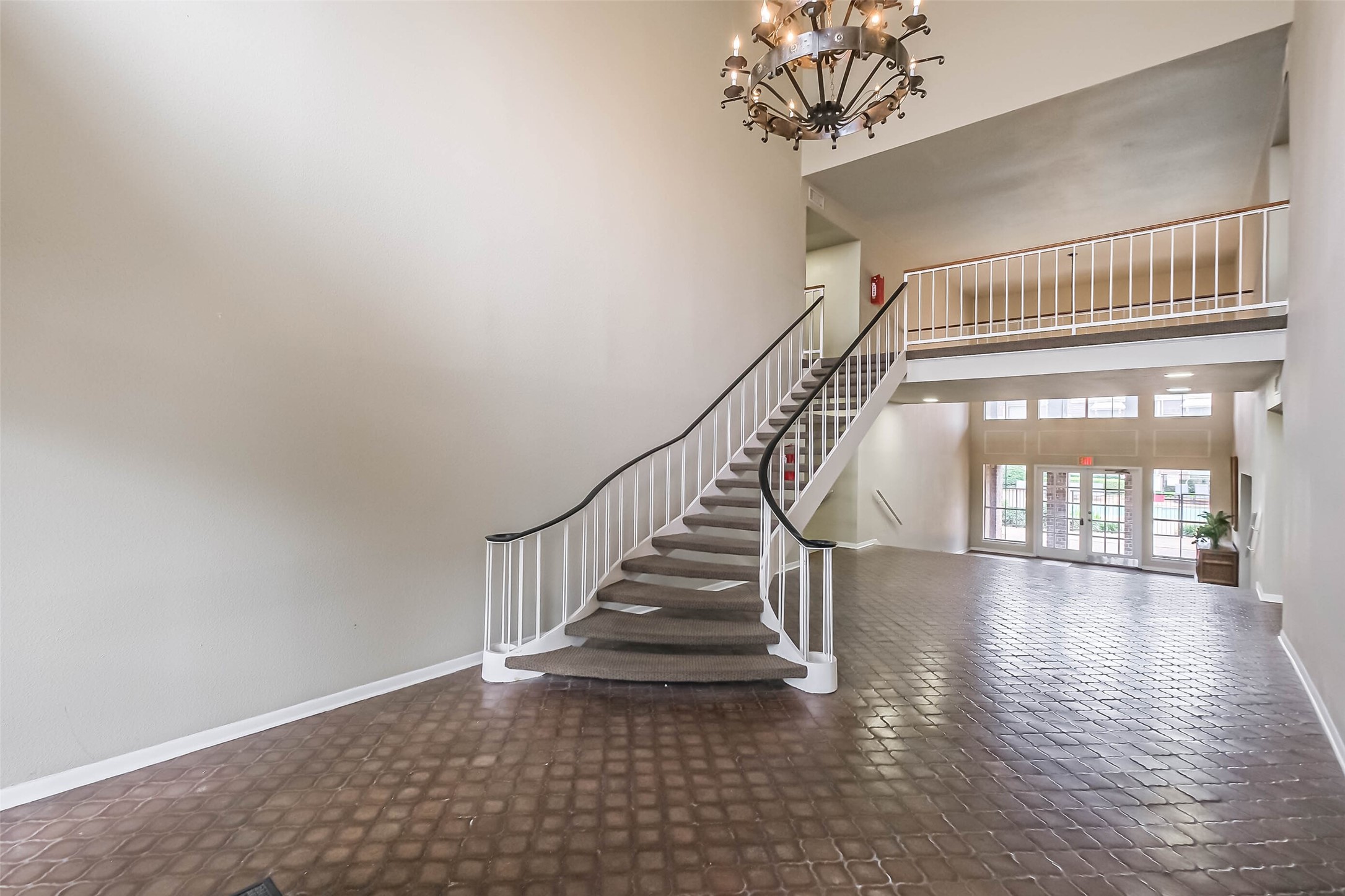 7575 Katy Freeway, Unit 101 Houston, TX 77024 - Photo 4 of 21 On entry, you are greeted by chandeliers and sweeping staircases.
