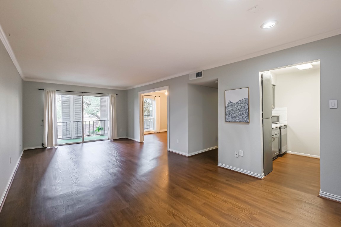 7575 Katy Freeway, Unit 101 Houston, TX 77024 - Photo 5 of 21 a view of a big room with wooden floor and windows