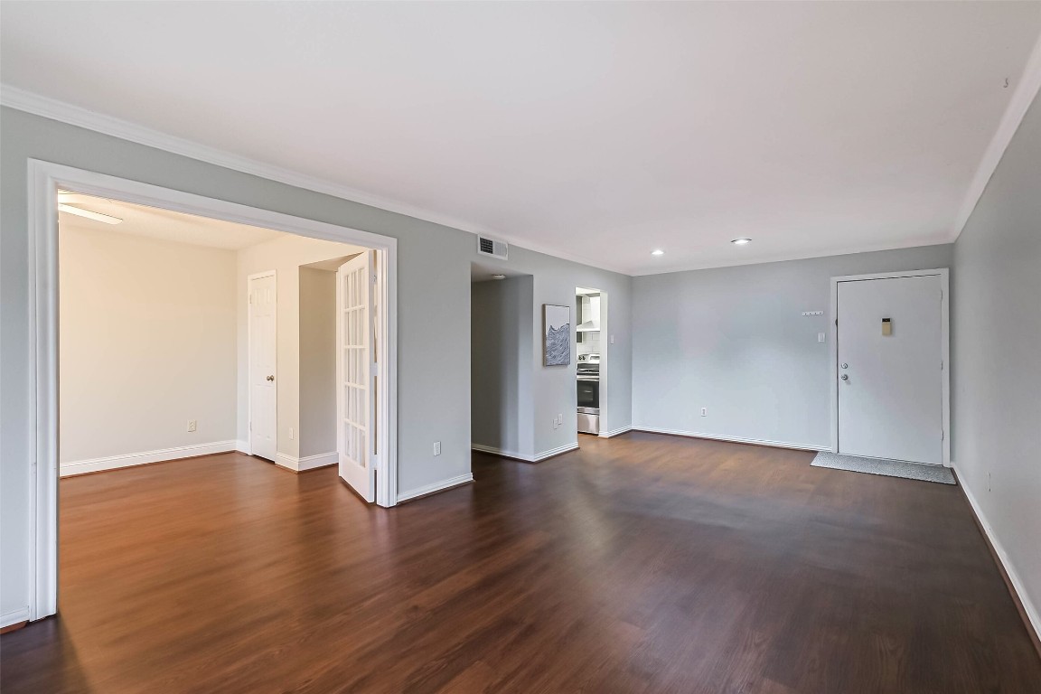 7575 Katy Freeway, Unit 101 Houston, TX 77024 - Photo 6 of 21 a view of an empty room with wooden floor and a window