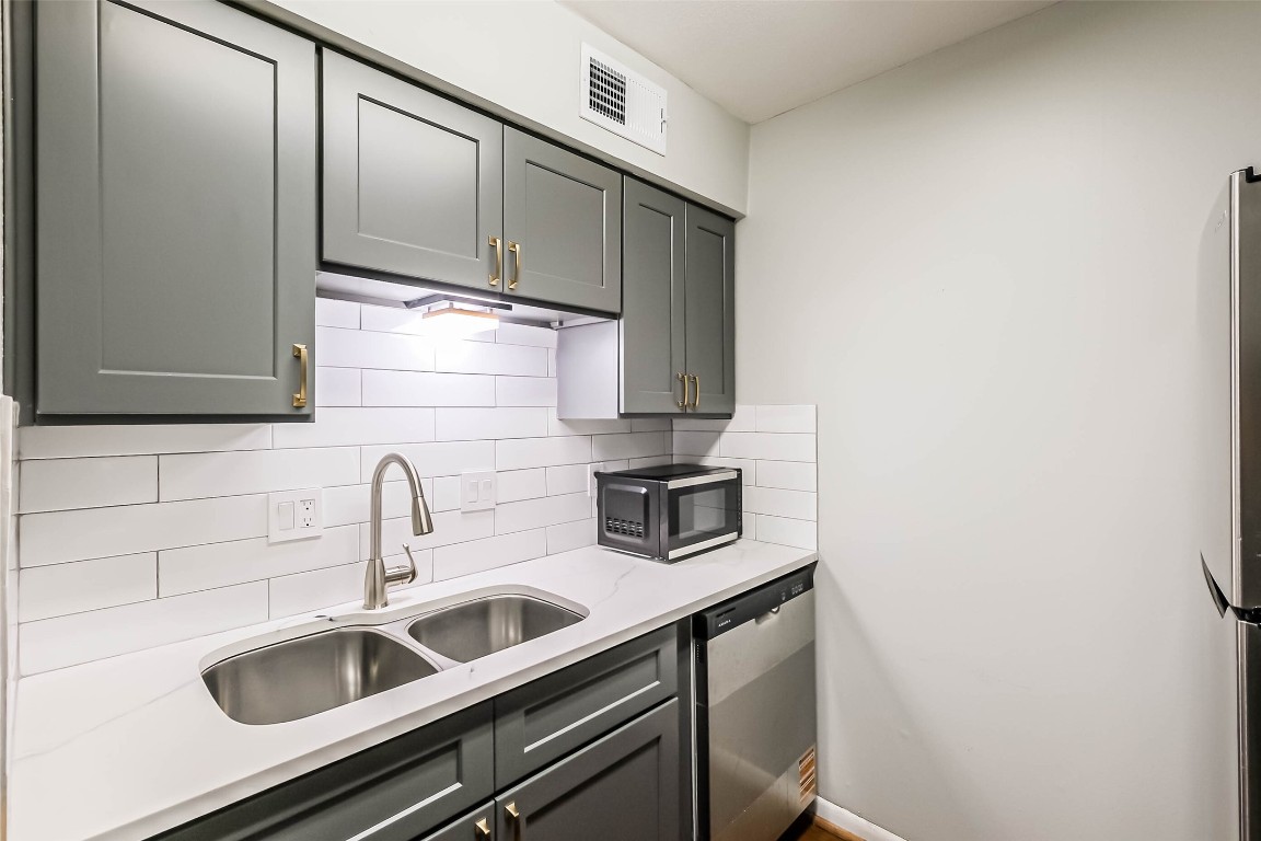 7575 Katy Freeway, Unit 101 Houston, TX 77024 - Photo 8 of 21 a kitchen with a sink and cabinets