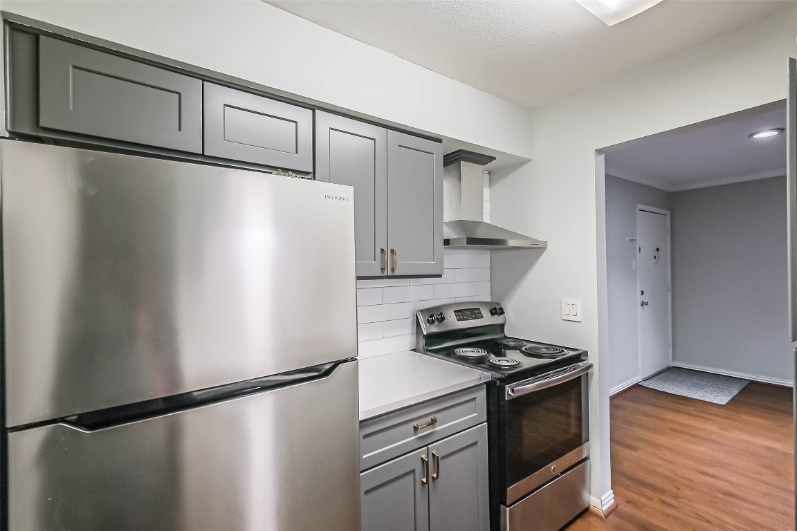7575 Katy Freeway, Unit 101 Houston, TX 77024 - Photo 9 of 21 a kitchen with stainless steel appliances granite countertop a refrigerator sink and stove