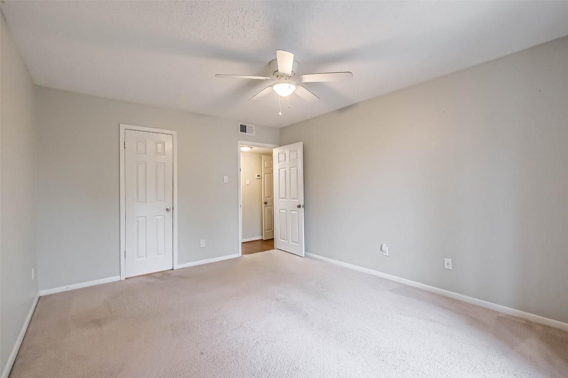 7575 Katy Freeway, Unit 101 Houston, TX 77024 - Photo 10 of 21 an empty room with closet and fan