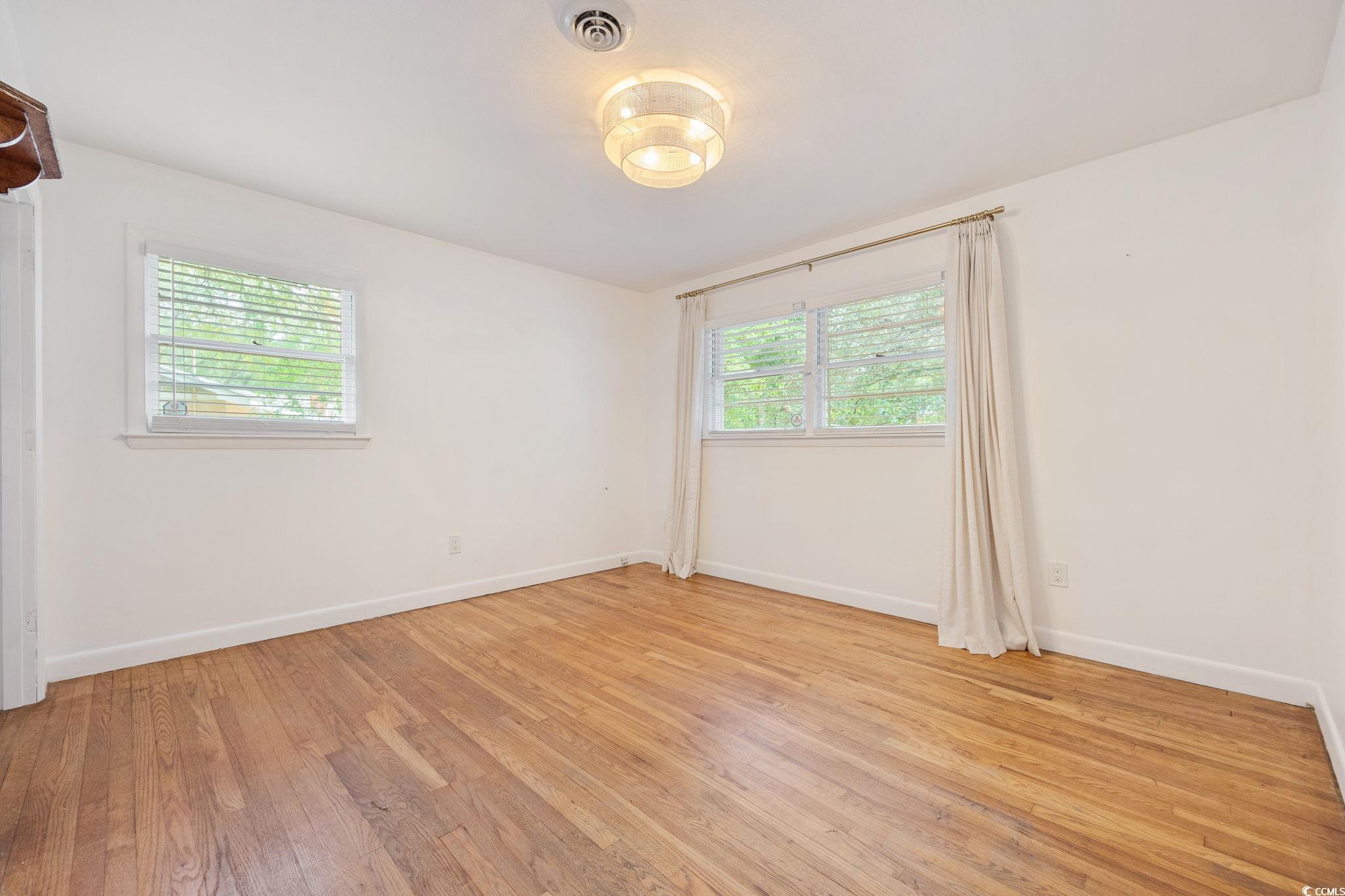 4303 Old Kings Highway Murrells Inlet, SC 29576 - Photo 17 of 34 Empty room featuring plenty of natural light and light wood finished floors