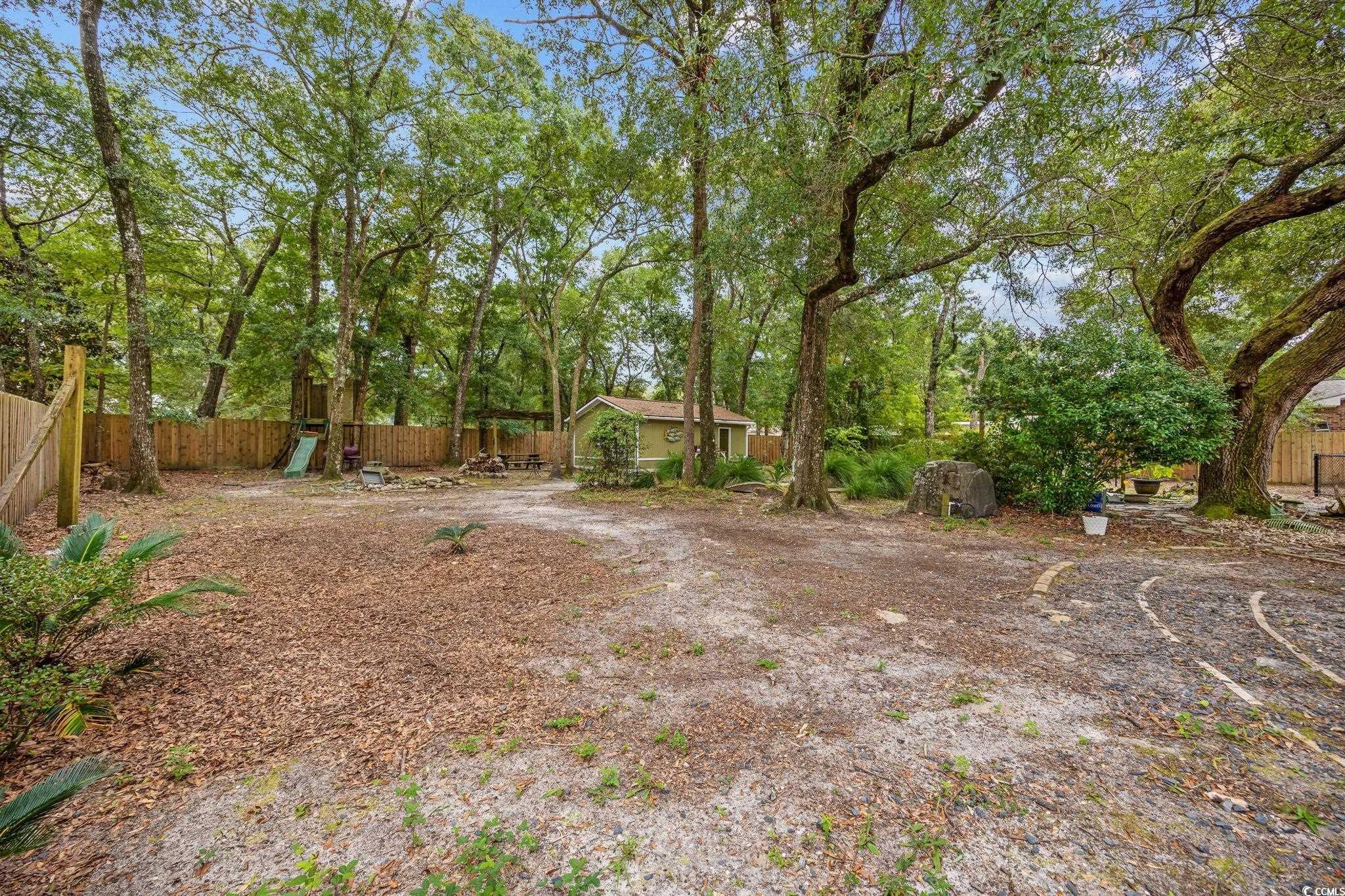 4303 Old Kings Highway Murrells Inlet, SC 29576 - Photo 29 of 34 View of yard featuring a sunroom and a deck