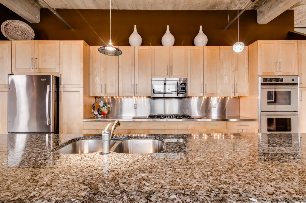850 West Adams Street, Unit 6D Chicago, IL 60607 - Photo 13 of 35 a kitchen with stainless steel appliances kitchen island granite countertop a refrigerator a stove and white cabinets with wooden floor