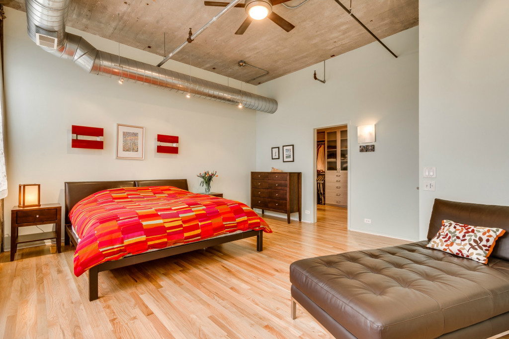 850 West Adams Street, Unit 6D Chicago, IL 60607 - Photo 23 of 35 a bedroom with a bed and a chandelier