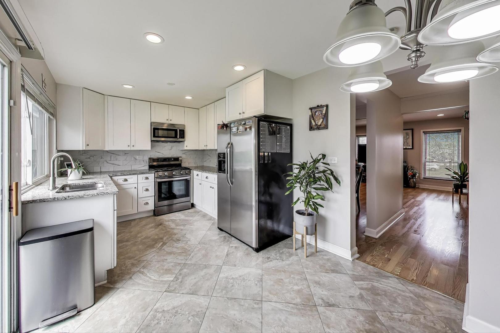 2067 Kettering Road Hoffman Estates, IL 60169 - Photo 7 of 28 a kitchen with a refrigerator and a sink