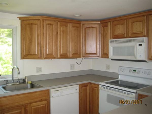 82 Teele Road Bolton, MA 01740 - Photo 4 of 12 a kitchen with granite countertop a sink a stove and cabinets