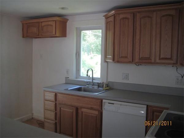 82 Teele Road Bolton, MA 01740 - Photo 7 of 12 a kitchen with granite countertop a sink cabinets and window